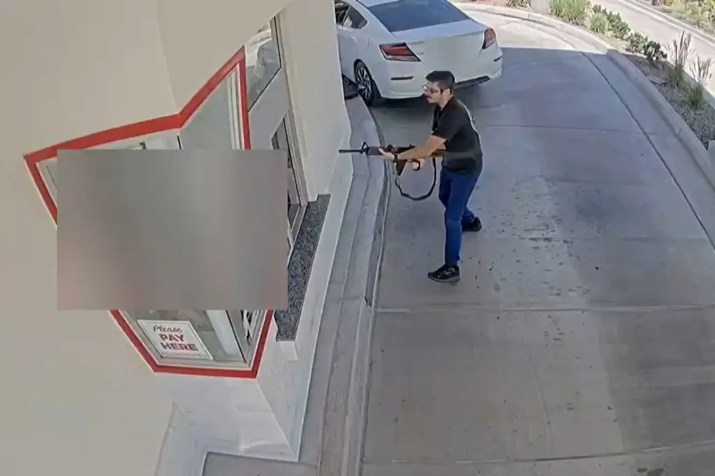 Chad Williams holds a rifle, aiming it towards the drive-thru window of an In-N-Out restaurant.