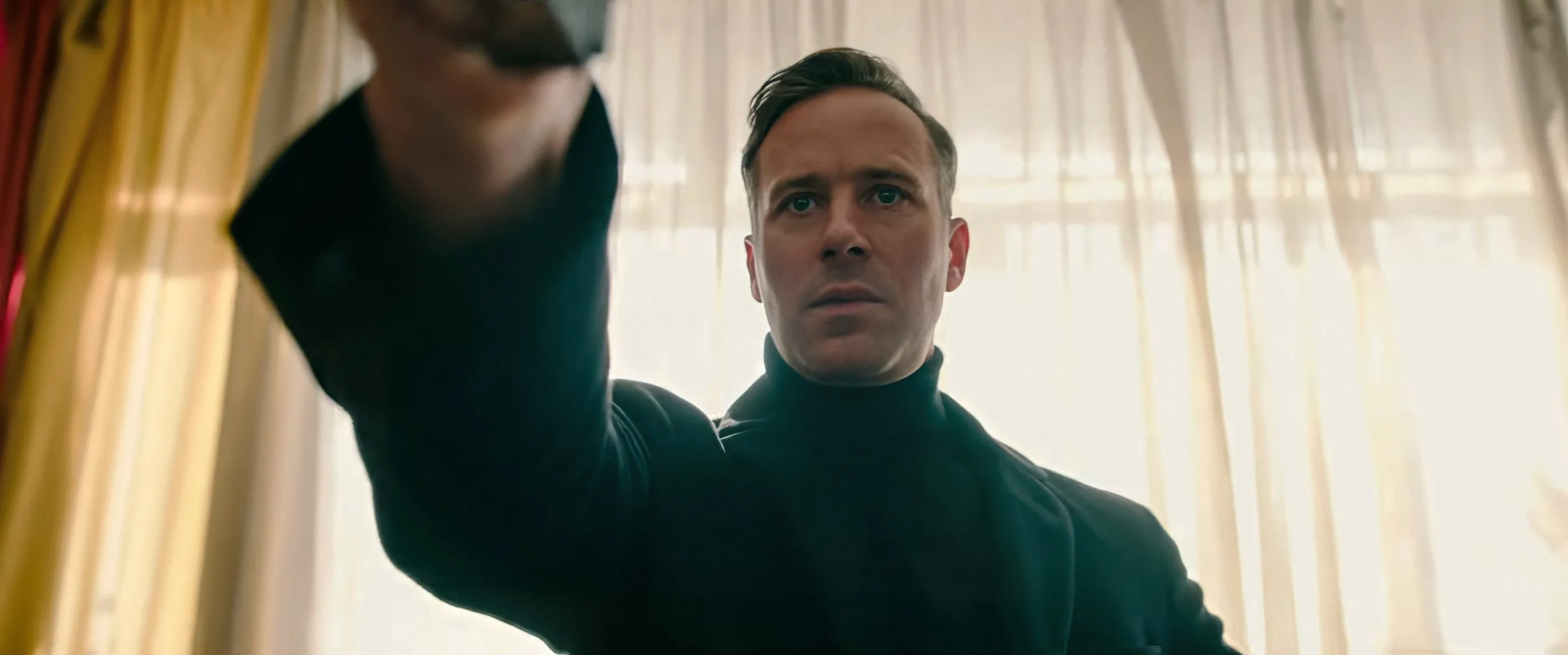 Armie Hammer as Citizen Vigilante, holding a gun from his perspective.