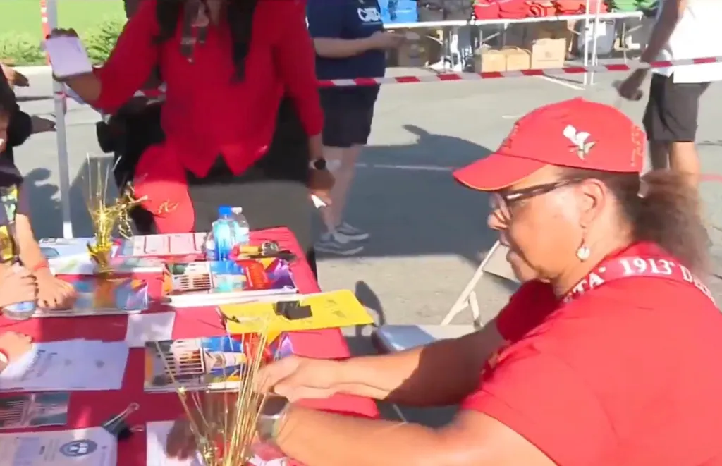 Volunteers distribute school supplies at an event for families.