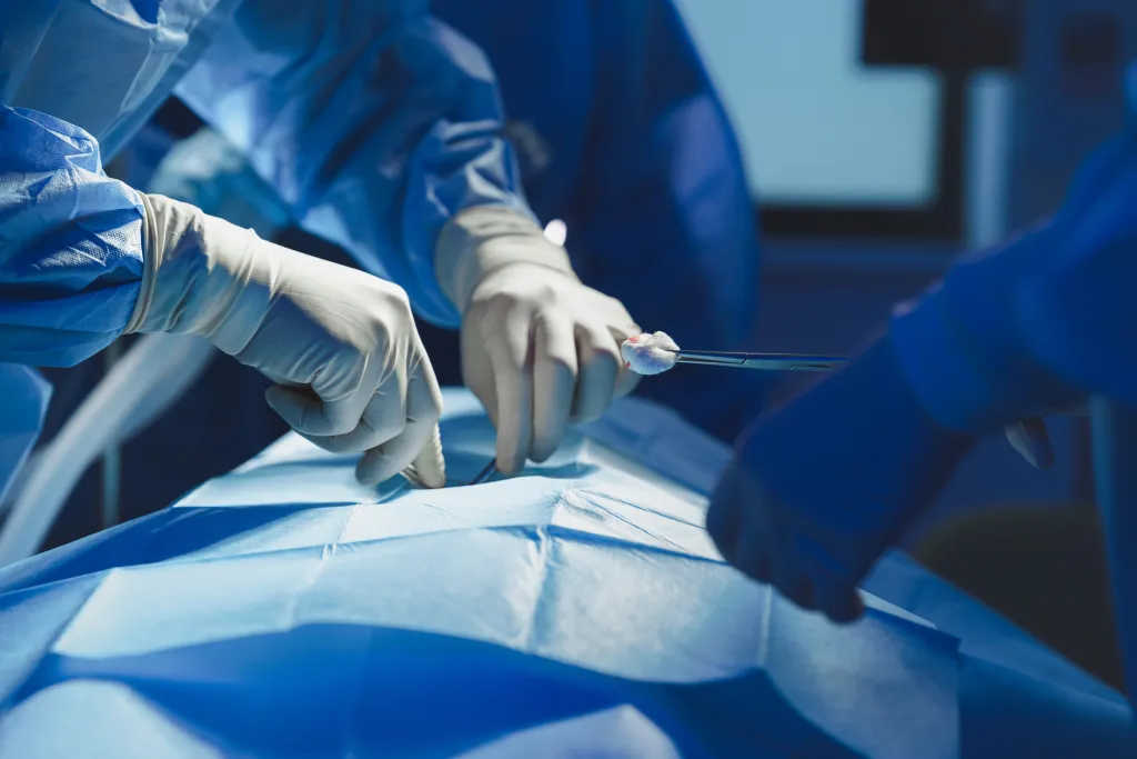 Close-up of a surgeon with a nurse and assistant during an operation.