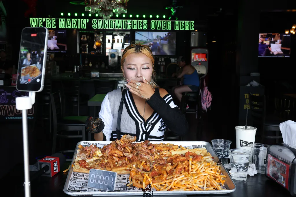Competitive eater Raina Huang about to eat the massive Big Fat Fatty sandwich from Fat Sal's.