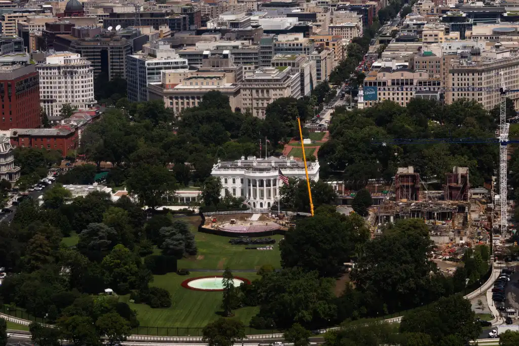 An aerial view shows the White House and ongoing construction on the South Lawn, with a helipad and ballroom being built.
