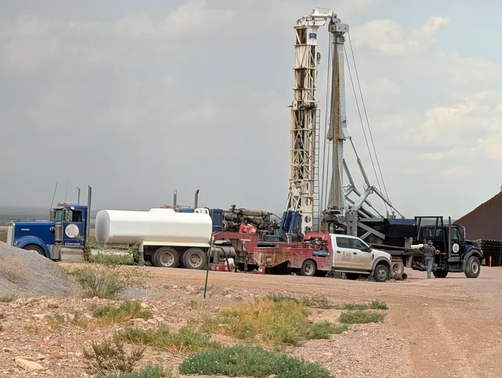 Construction crews drill wells for border wall construction.