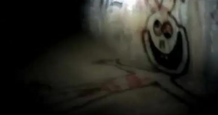 A figure resembling a snowman, and a cartoon character on the wall of a dark tunnel.