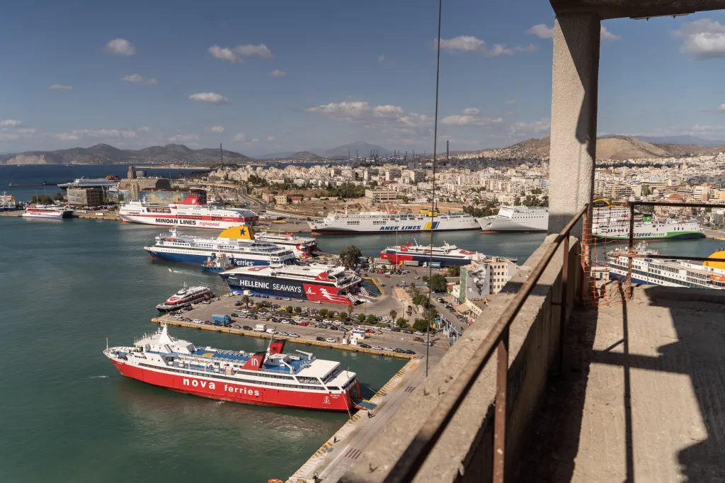 Cruise ships and passenger ferries in the Port of Piraeus, Greece, seen from the Piraeus Tower redevelopment construction site.