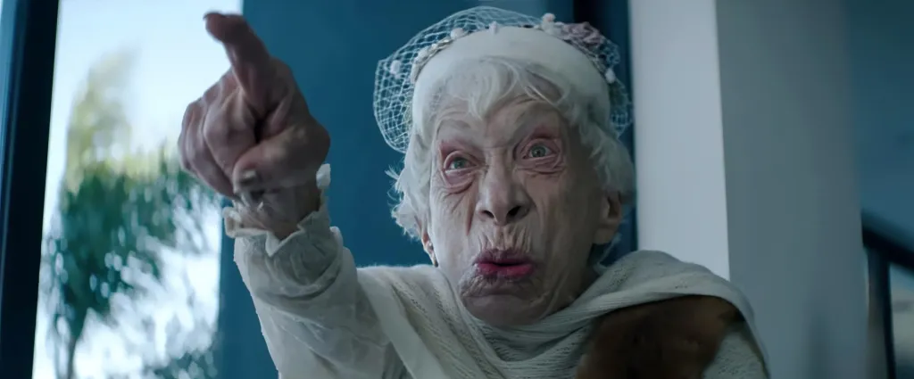 Bunny Levine in a close-up portrait with her eyes wide and mouth agape, pointing her finger.