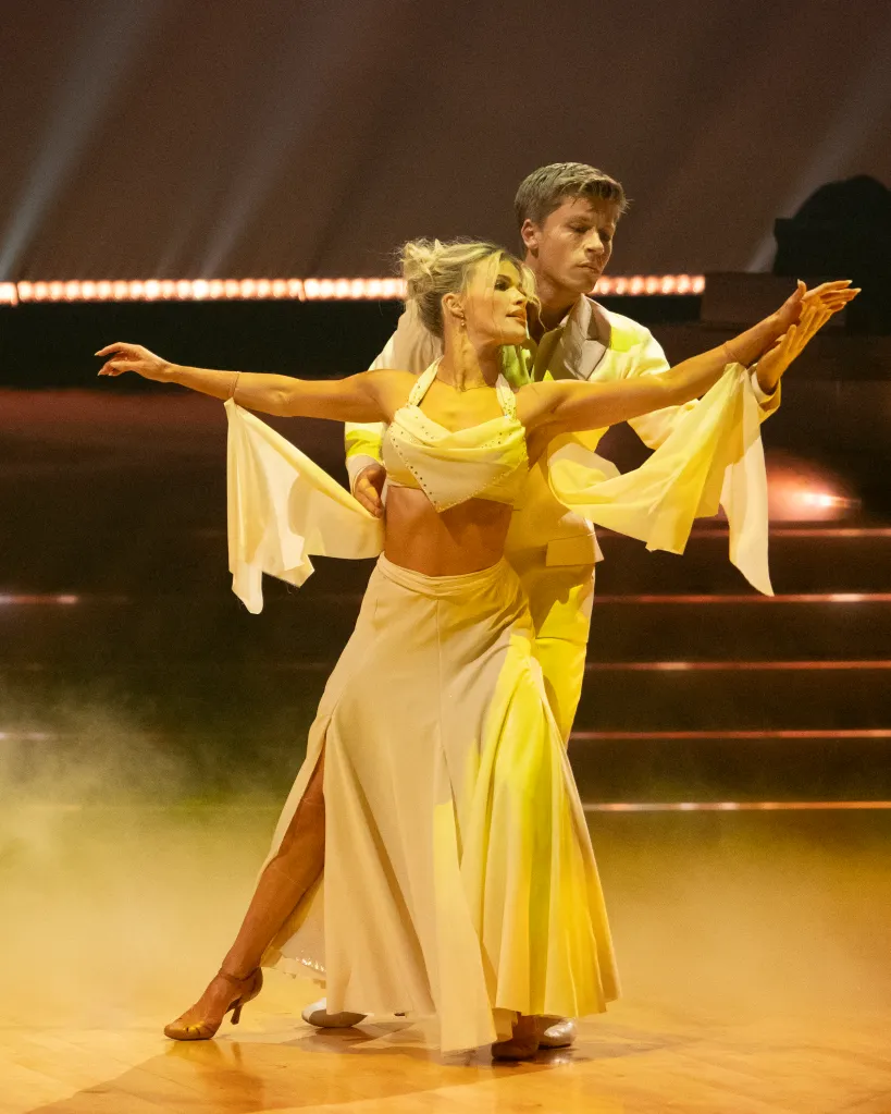 Witney Carson and Robert Irwin dancing in yellow and cream outfits.