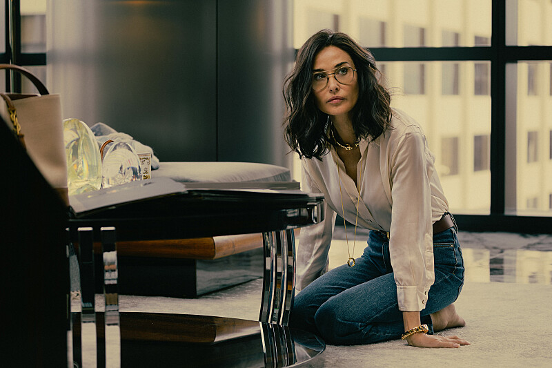 Demi Moore , in a white shirt and blue jeans and glasses, as Cami in Landman episode 3, season 2.