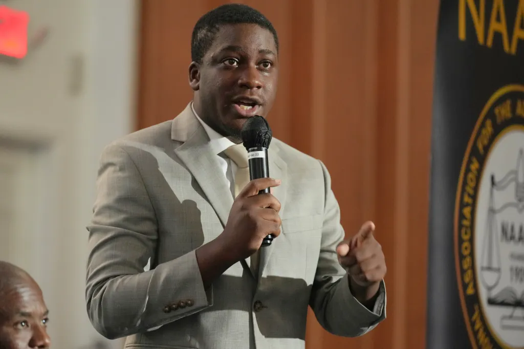 Democratic candidate Elijah Manley speaking into a microphone.