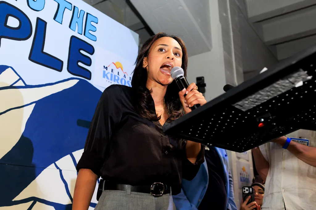 Democratic congressional candidate Melat Kiros speaks into a microphone at an election-night watch party.
