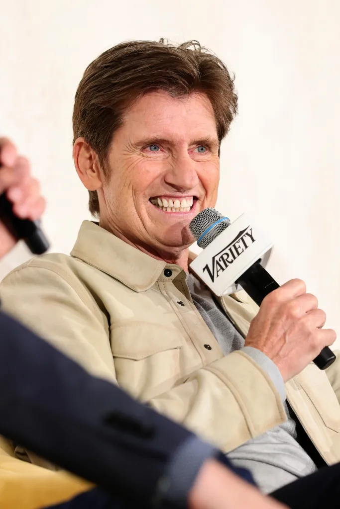 Denis Leary speaking into a microphone with the 
