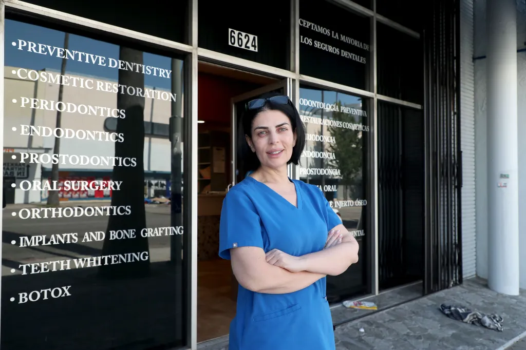 A dental assistant stands outside her workplace on Van Nuys Boulevard.
