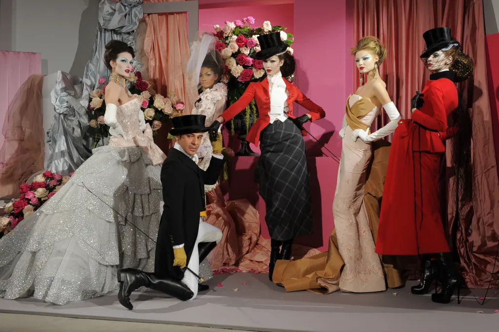 Designer John Galliano poses with models at the Christian Dior Haute Couture show during Paris Fashion Week.