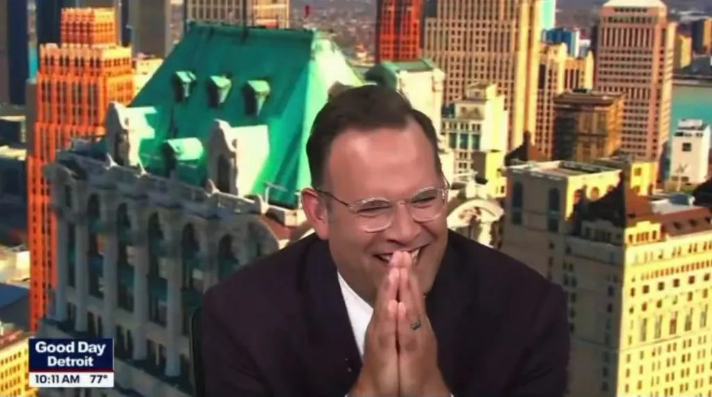 Detroit news anchor Ryan Ermanni cracks up over a question from co-host Deena Centofanti on the Fox 2 TV broadcast of