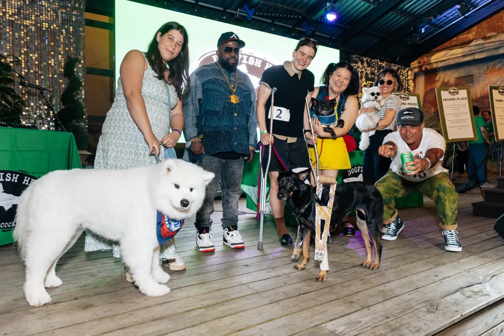 People and dogs posing at the Dogfish Head Look-a-Like contest.