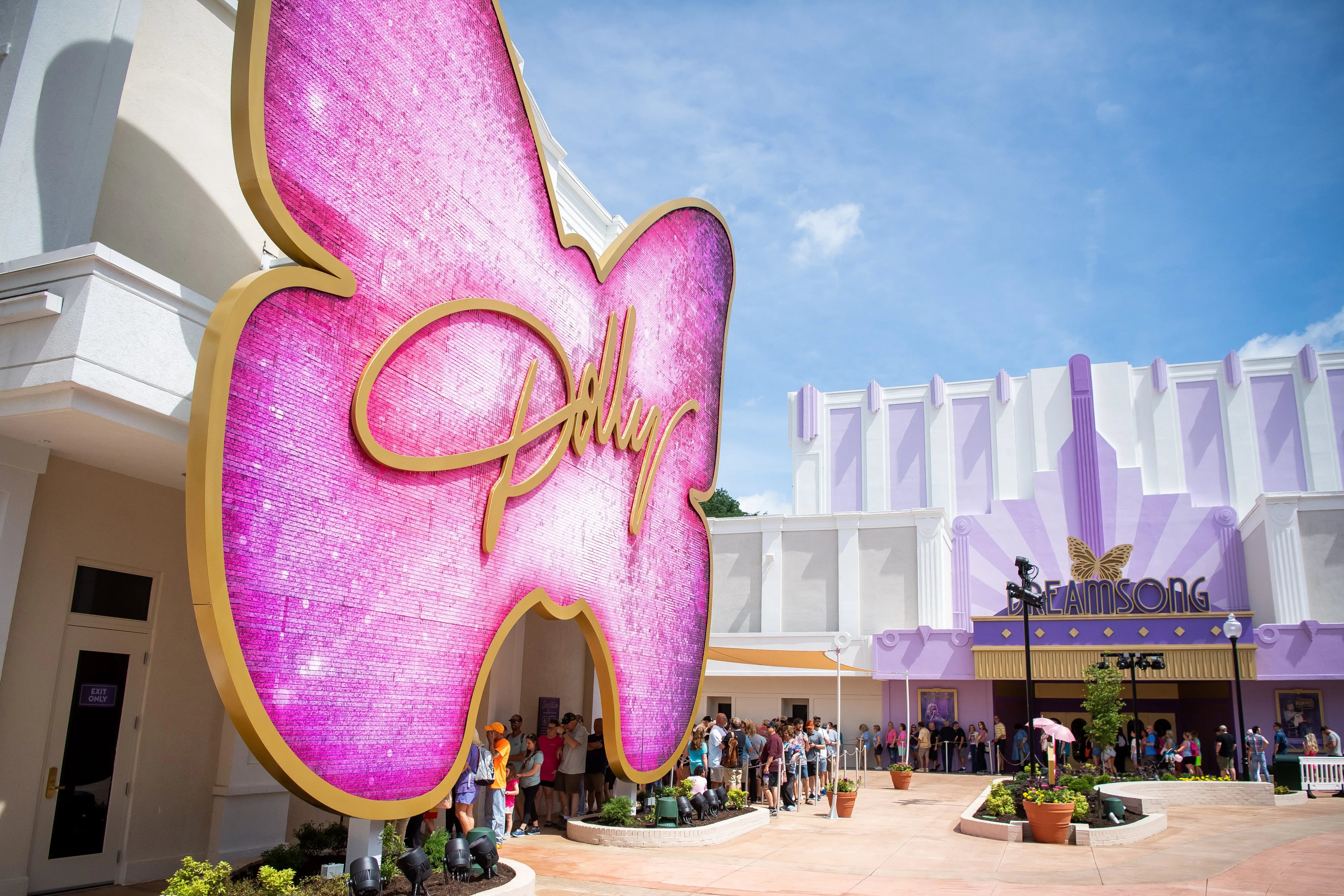 People waiting in line outside The Dolly Parton Experience's Songteller exhibit and Dreamsong Theater at Dollywood.