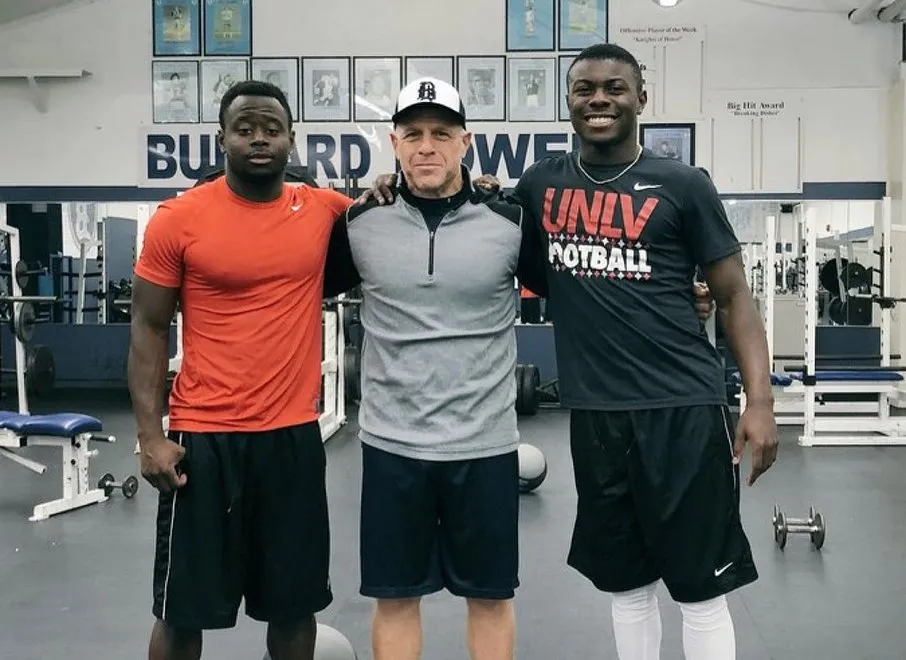 Don Arax (middle) with two athletes in a gym.