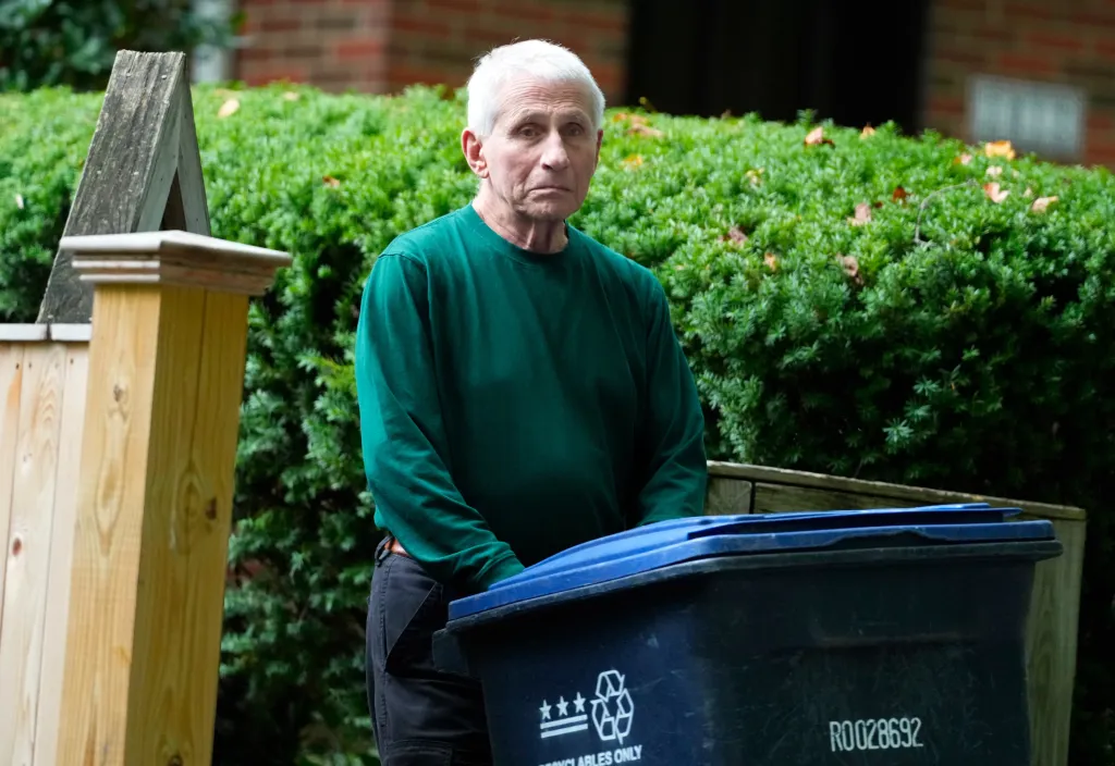 Dr. Anthony Fauci retrieving trash cans outside his Washington, DC home.