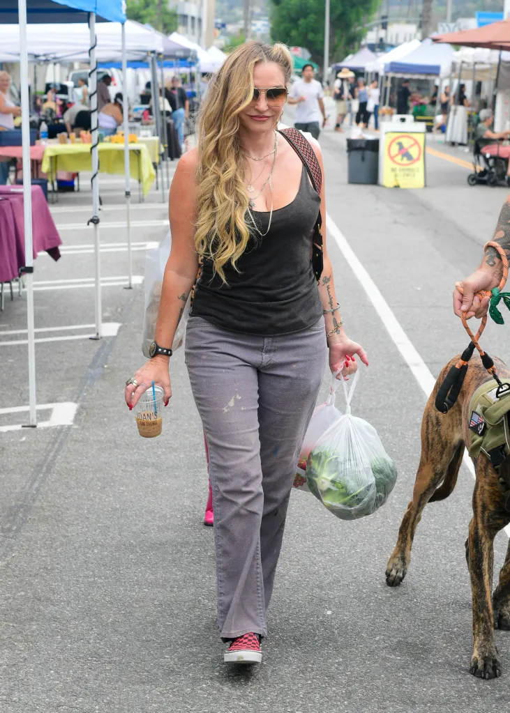 Drea de Matteo walks with a bag of produce and an iced coffee.