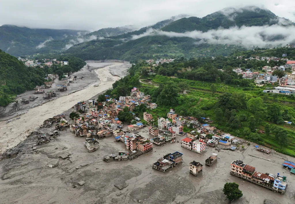 Drone view of mud covering buildings and property after a flash flood in Trishuli, Nepal.