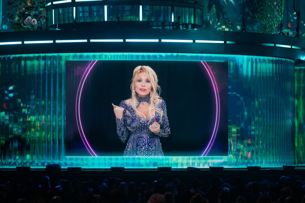 Dolly Parton appears on a large screen at the BRIT Awards.