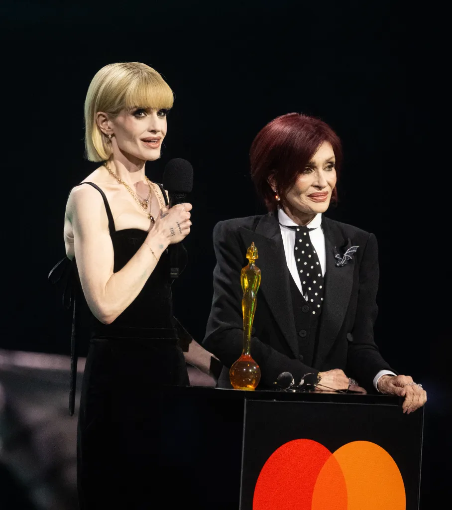 Kelly Osbourne and Sharon Osbourne on stage accepting the Lifetime Achievement Award.
