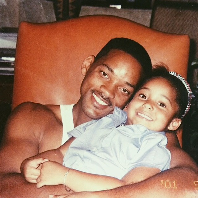 Will Smith smiling and holding a young Jordyn Woods.