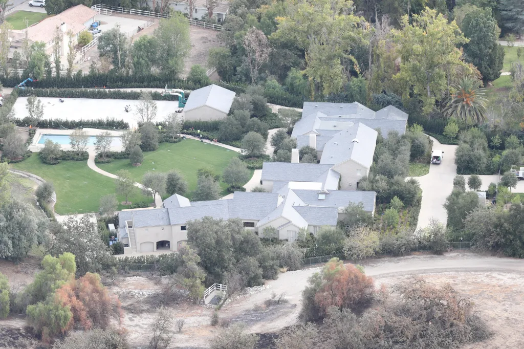 Aerial view of Kim Kardashian and Kanye West's home with white water spots on charred brush fields.