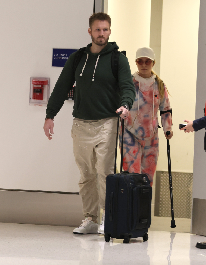 Hayden Panettiere on crutches with Brian Hickerson at LAX.