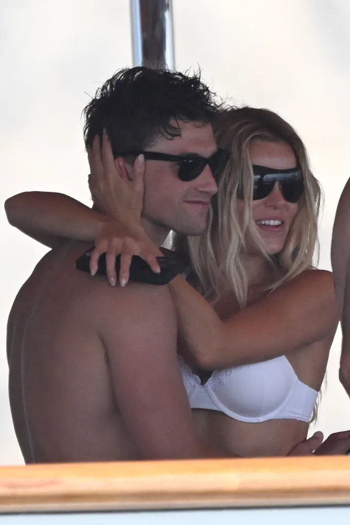 Brooks Nader and Jack Lumsden embrace on a yacht.