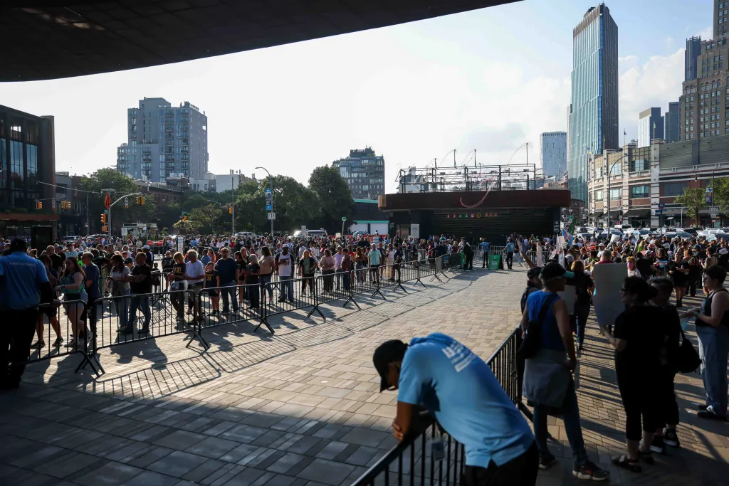 Fans arriving for a WNBA game, with some participating in rallies and protests regarding transgender inclusion.