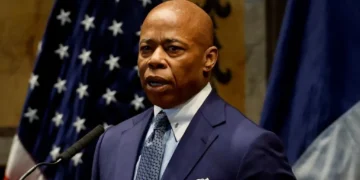 ‘You belong in prison!’ Angry crowd  shouts down Trump pal