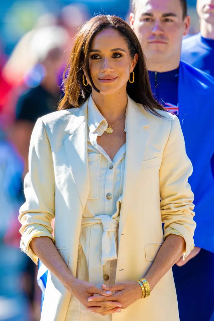 Meghan Markle, Duchess of Sussex, in a cream blazer and romper.