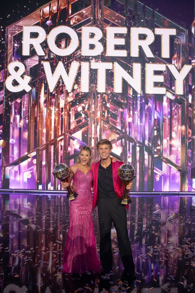 Witney Carson and Robert Irwin celebrating with their trophies.
