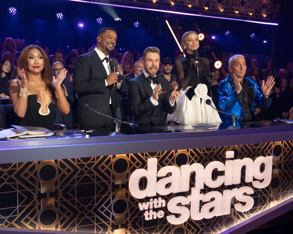 Carrie Ann Inaba, Alfonso Ribeiro, Derek Hough, Julianne Hough, and Bruno Tonioli clapping at the judges' table during the 