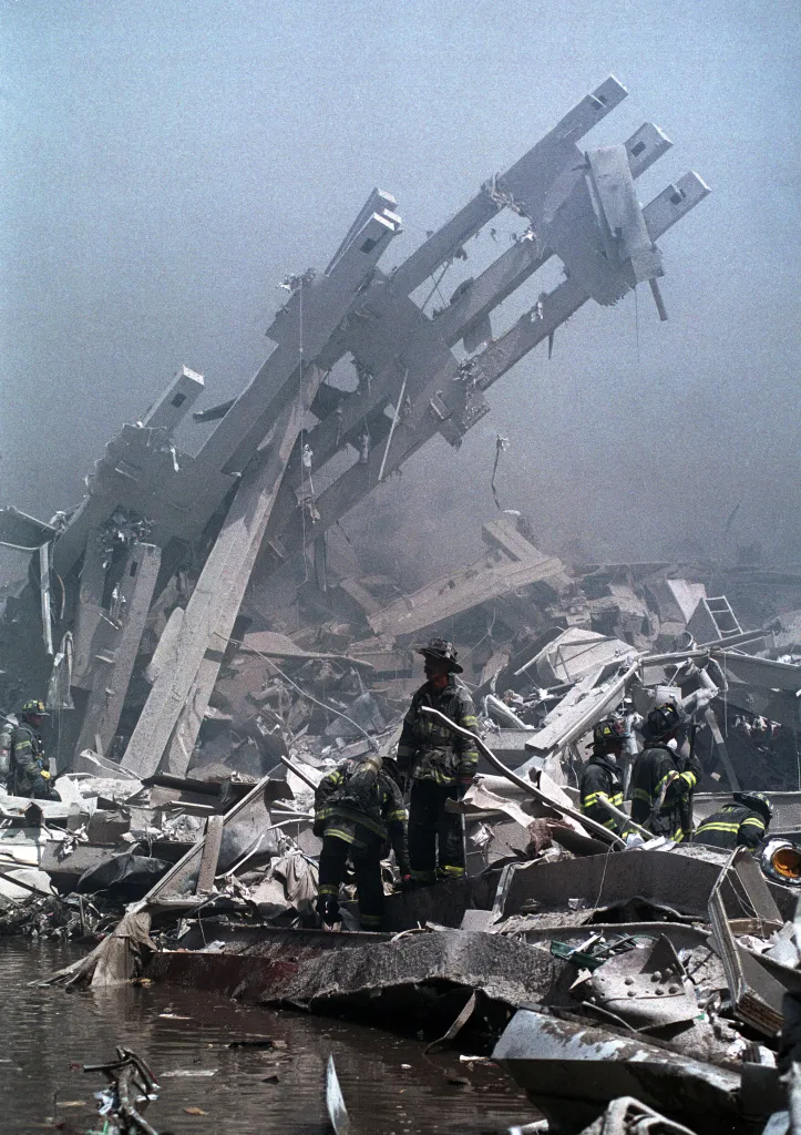 Firefighters navigate the rubble of the World Trade Center.
