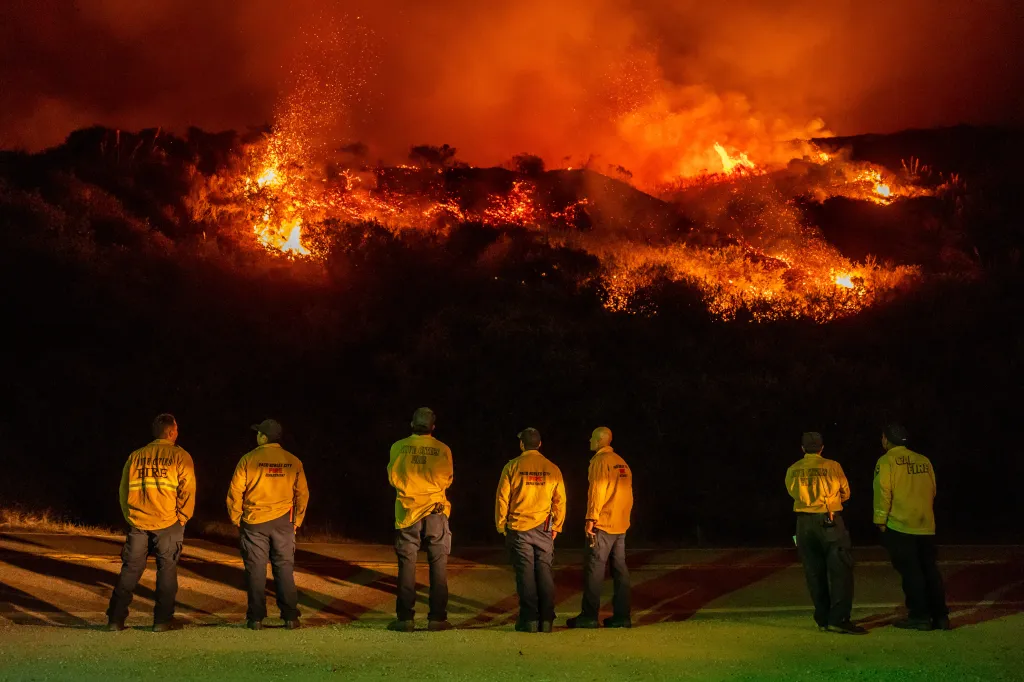 Firefighters watch the Plaskett Fire burn towards Highway 1 in Big Sur, California.