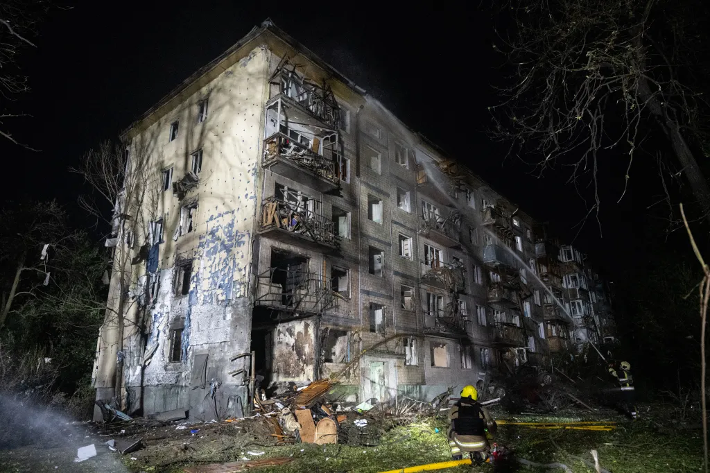 Firefighters battle flames at a building damaged during the overnight attack.