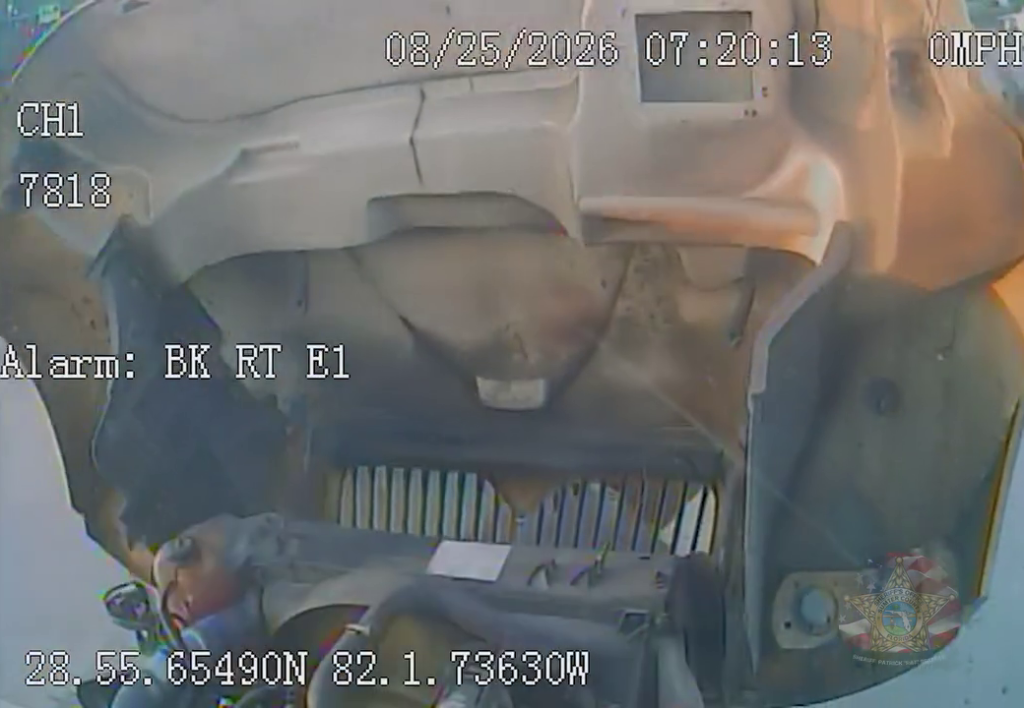 Vehicle dashboard camera footage from a car that crashed head-on with a school bus.