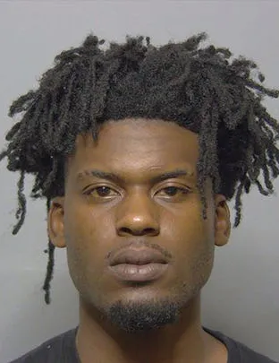 Mugshot of Qahiem Williams, a Black man with dreadlocks and a goatee.
