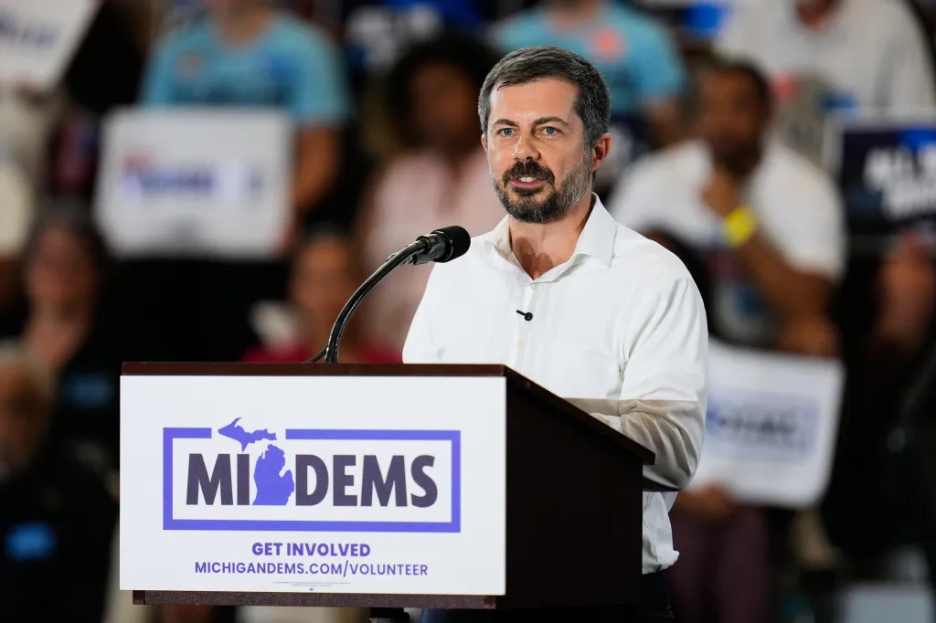 Pete Buttigieg speaking at a podium with 