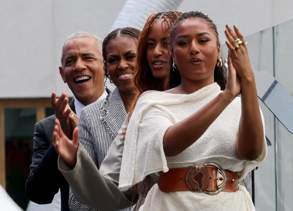 Former President Barack Obama, former first lady Michelle Obama, Malia Obama and Sasha Obama cheer after the performance of Eddie Vedder and Guitars Over Guns during the dedication ceremony for the opening of the Barack Obama Presidential Center in Chicago, Illinois, on June 18, 2026.