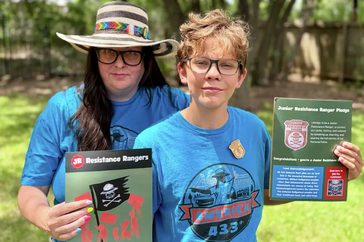 Melissa Dalley and a child hold up