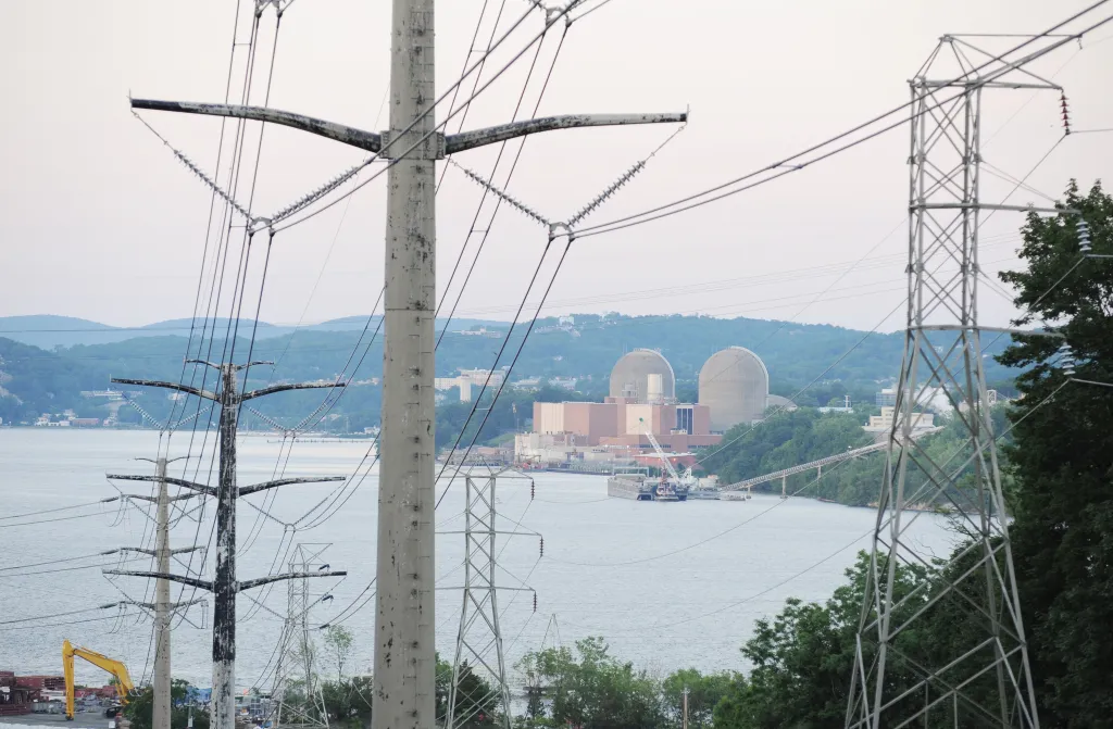 Indian Point Nuclear Power Plant seen from Stony Point, NY, with power lines in the foreground.