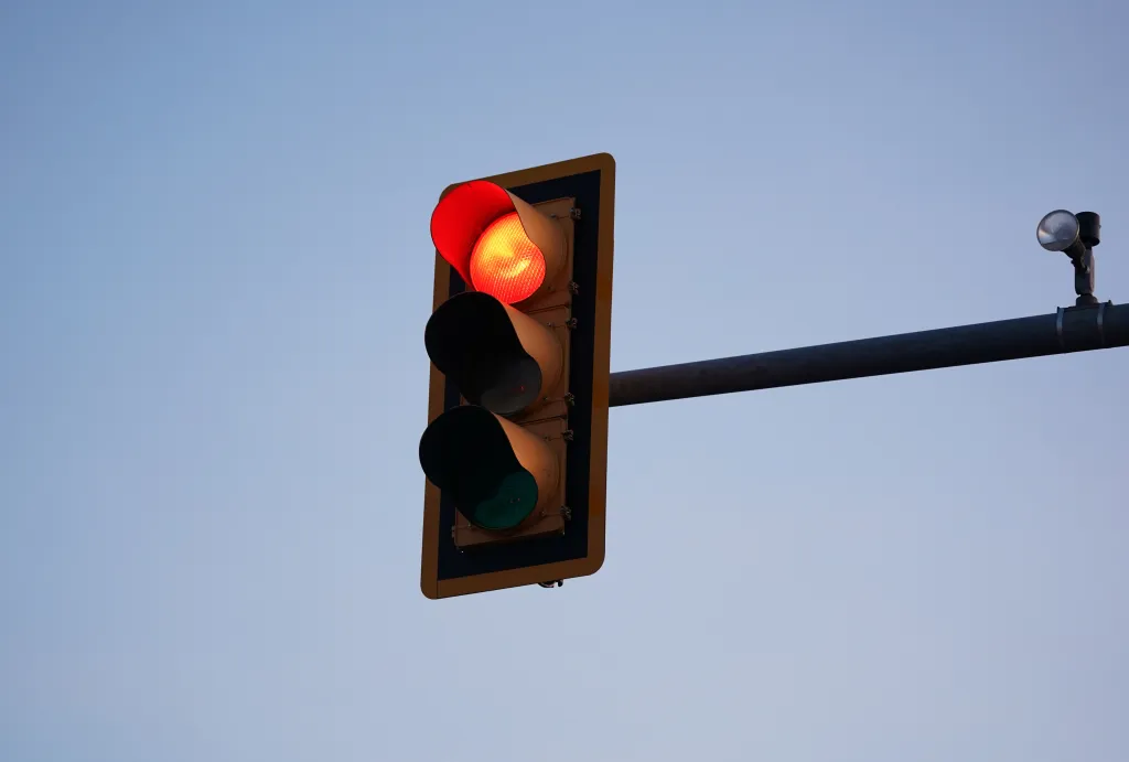 A red traffic light against a clear sky in Mount Pocono, PA.