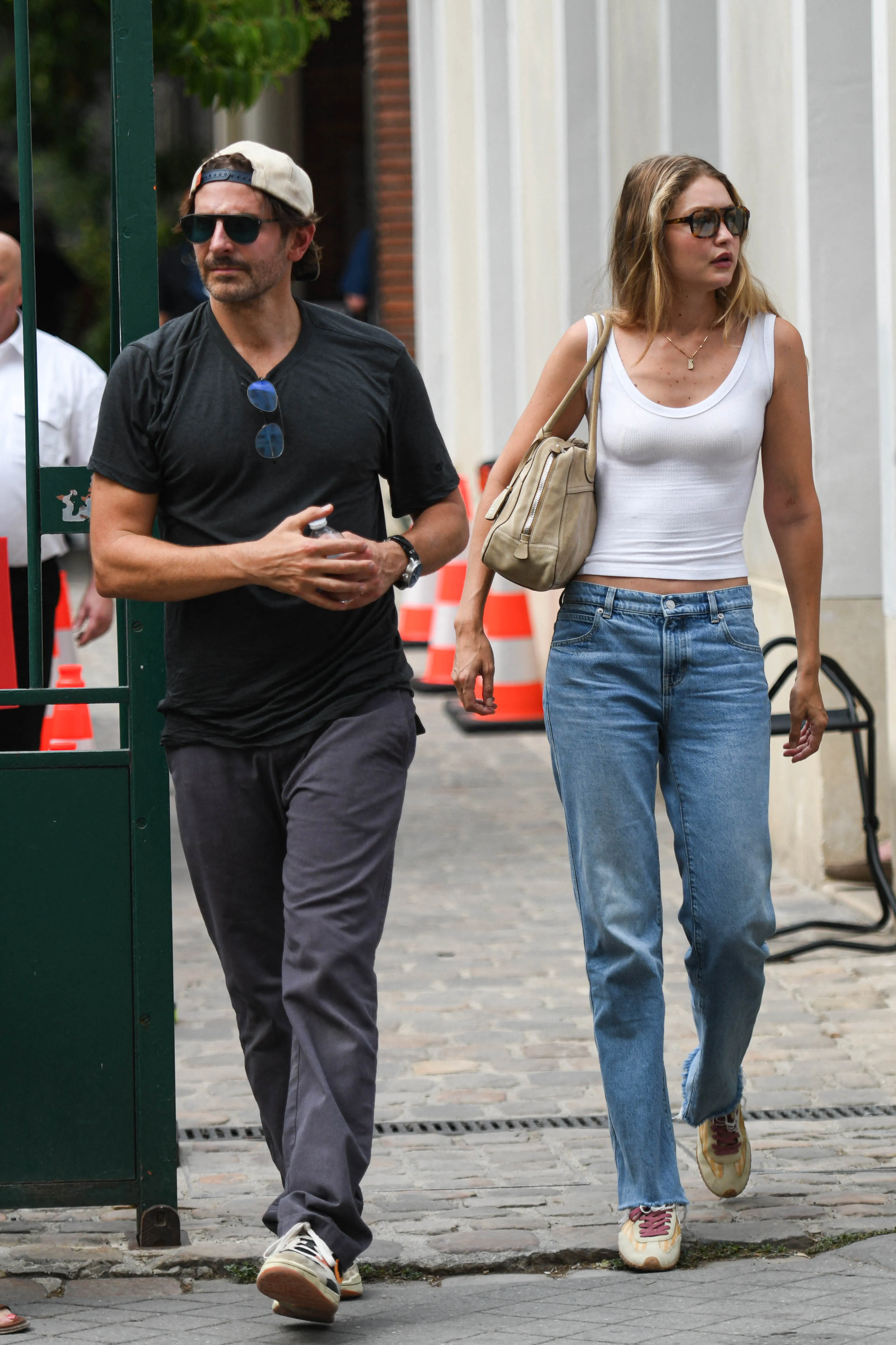 Gigi Hadid and Bradley Cooper walking on the set of the 'Ocean's Eleven' prequel in Paris, France.