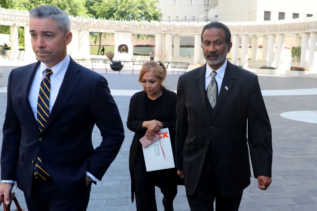 Gladwin Gill and his wife Amelou exiting federal court.