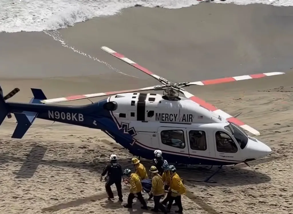 Medical personnel carrying a stretcher towards a