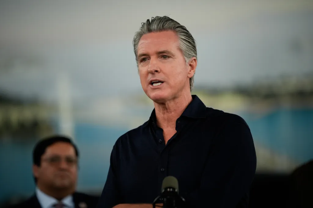 Governor Gavin Newsom speaks at an event promoting electric vehicle savings and clean energy.