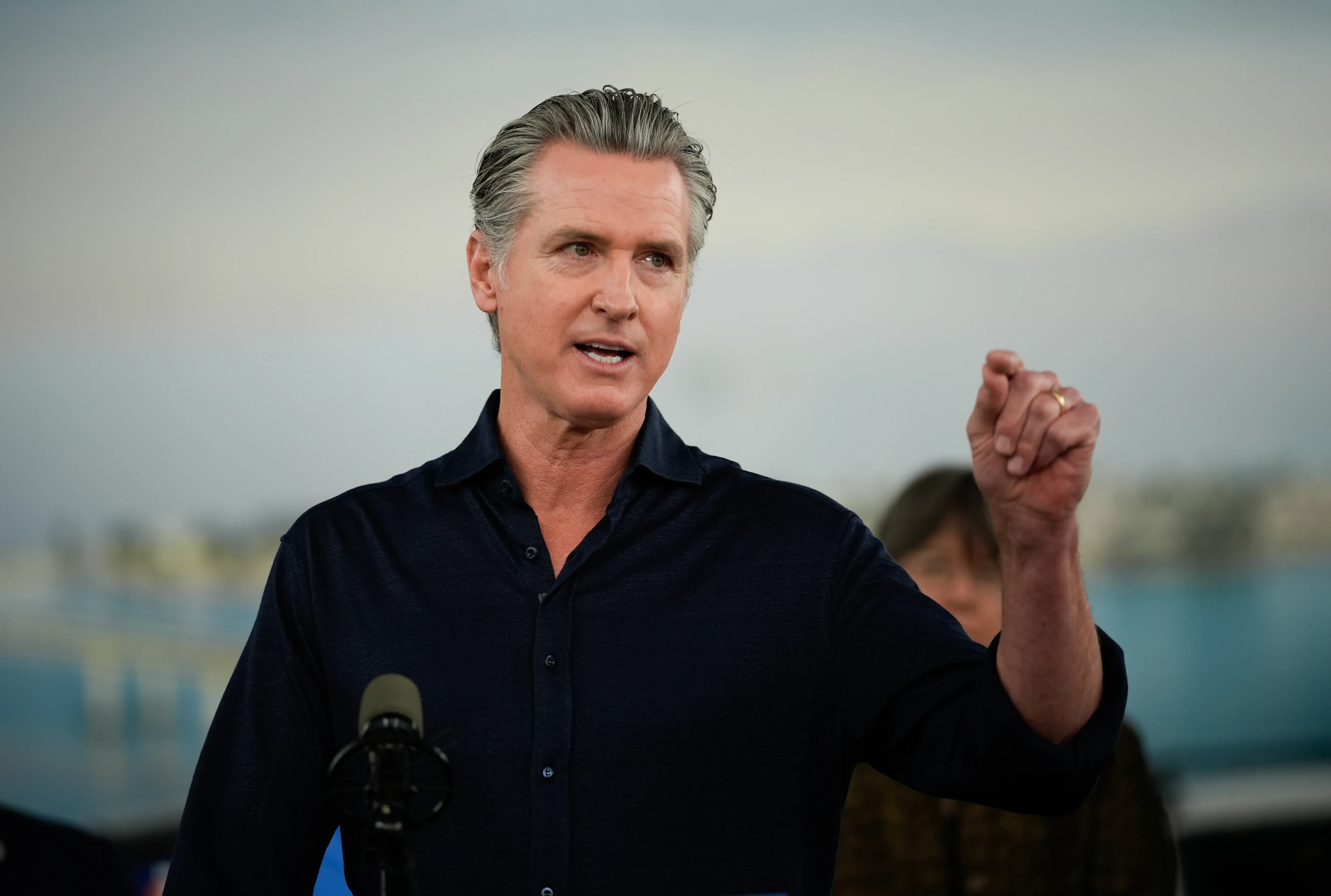 Governor Gavin Newsom speaking at an event about clean energy and electric vehicles.